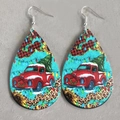 Detail of teardrop leather earrings featuring a vintage red truck and Christmas tree design - Christmas Red Truck (1)