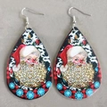 Macro detail of teardrop leather earrings featuring leopard beard Santa and floral patterns - Leopard Beard Santa (6)