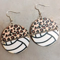 Detail of round volleyball earrings with leopard print and wood grain texture - Volleyball Style
