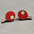 Close-up of red ping pong paddle earrings with green ball detail on grey background - Table Tennis Racket Style (1)