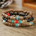 Macro shot of bohemian layered coconut shell beads with turquoise and red accents - Polished Coconut Shell Bohemian Style (ZJ14232)