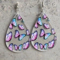 Macro shot of teardrop acrylic earrings with colorful butterfly prints and silver hooks - Colorful Butterfly Style (5000809597261)