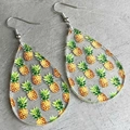 Macro detail of teardrop acrylic earrings with vibrant pineapple pattern and metal hooks - Pineapple Pattern