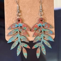 Macro shot of vintage hollow leaf earrings with colorful textures on a craft card - Oak Leaf Style (5040431684426)