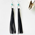 Detail of bohemian black leather fringe earrings with turquoise beads and silver ring - Black