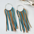 Detail of oversized silver hoop earrings with mixed brown and blue suede tassels - Brown and Blue