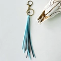 Detail of vintage boho keychain with sky blue and black tassels and bronze clasp - Blue Black