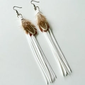 Detail view of bohemian brown feathers and white long tassel earrings with metal hooks - White