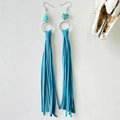 Detail of western turquoise drop earrings with vibrant blue leather fringe and metal rings - Teal