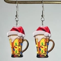 Close-up of acrylic Christmas beer mug earrings with festive Santa hat and light pattern - Beer Mug Santa Hat