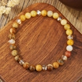 Macro detail of mixed natural crystal beads on a handmade elastic beaded bracelet - Yellow And Brown Texture Natural Stone Mixed Style (ZJ15842)