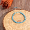 Adjustable light blue natural stone beaded bracelet with silver spacers on wood - Aqua Blue Translucent Beaded Bracelet (ZJ13525)