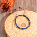 Adjustable hand-woven bracelet featuring blue cylindrical Lapis Lazuli beads and gold spacers - Lapis Lazuli Blue Beaded Bracelet (ZJ13527)