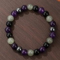 Kralenarmband met amethist, obsidiaan en tijgeroog stenen op houten achtergrond - Amethist Obsidiaan Magnetiet (ZJ14171)
