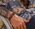 Detail view of men's beaded wrap bracelet with tiger eye stones on a tattooed wrist - Tiger Eye Brown and Black (ZJ13673)