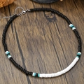 Handgemaakte kralenketting met zwart-wit-turquoise schijfjes op rustiek houten achtergrond - Zwart Wit Turkoois Platte Kralen Stijl (ZJ12975)