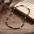 Ethnic beaded necklace featuring wood beads with turquoise accents and lobster clasp - Brown and Blue Natural Style (ZJ11057)