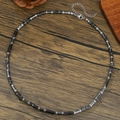 Men's necklace with stainless steel beads and snowflake stone on wooden background - Black Stone with White Spots and Metal Spacer Style (ZJ14814)
