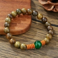 Vintage wooden bead bracelet with green agate and orange spacers on a rustic wood board - Olive Green Wood Bead Agate Style (ZJ14820)