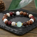 Handmade wooden and agate bead bracelet with golden spacers on a natural stone surface - Multicolor Wood Bead Light Green Style (ZJ14822)