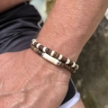 Close-up of stacked set with dark wood beads and white shell disks on male wrist - Dark Brown Wood Alternating Disk Style (ZJ12977)