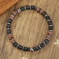 Close-up of black lava stone and red natural crystal beaded bracelet on wooden background - Lava Stone Red Agate Style (ZJ15027)