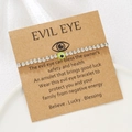 Detail of silver beaded Evil Eye bracelet on a kraft card with inspirational message - Green (ZJ15631)