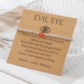 Detail of silver beaded evil eye bracelet on brown gift card with emotional message - Red (ZJ15636)