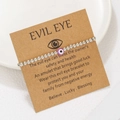 Detail of silver CCB beaded Evil Eye bracelet on kraft card with purple eye charm - Purple (ZJ15637)