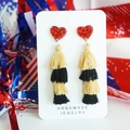 Detail of layered gold and black tassel earrings with a red sequined heart top - Black Gold Style 7