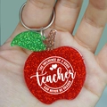 Close-up of glittery apple keychain with teacher appreciation quote on silver ring - THE INFLUENCE OF A GOOD teacher... (Apple)