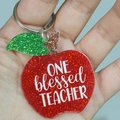 Close-up of a red glitter apple keychain with ONE blessed TEACHER text for gift - ONE blessed TEACHER (Apple)