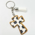 Detail of wooden cross keychain with football pattern and white leather tassel - Soccer Style