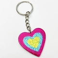 Macro detail of triple-layered heart keychain with neon glitter and metal split ring - Rose Red Blue Yellow Heart Style