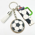 Detail view of soccer themed wooden keychain with football print charms and white tassel - Soccer Style