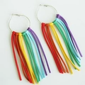 Detailed close-up of vibrant rainbow faux suede fringe hanging from large silver hoops - Large Hoop Rainbow Tassel Style (7)