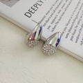 Dettaglio di orecchini a goccia in argento con finitura lucida e pavé di cristalli fini - Stile Pavé Goccia Argento / Color Acciaio (NHFT-021)