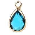 Detail of tear-drop shaped blue birthstone pendant with elegant gold plating finish - January (P1096)