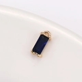 Detailed macro view of a rectangular dark blue crystal pendant with gold claw setting - 4mm*8mm / Blue (P1734)