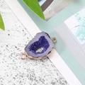 Macro-opname van een paarse druzy hanger met vergulde koperen rand voor sieraden - Donkerblauw