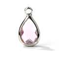 Macro shot of a faceted teardrop pink glass pendant with a polished silver-colored frame - Silver Border April (P2296)