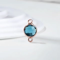 Detailed macro of a sea blue crystal faceted pendant in rose gold finish double loops - Diameter 8mm / 10 Pieces Pack / Rose Gold Edge-December (P2407)