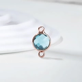 Macro detail of a rose gold birthstone charm with light blue faceted crystal and dual loops - Diameter 8mm / 10 Pieces Pack / Rose Gold Edge-March (P2406)