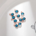 Macro detail of multi-faceted deep blue birthstone pendants with rose gold metal base - Rose Gold December (P2448)