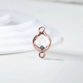 Macro view of a round rose gold connector with a clear birthstone for DIY jewelry - Diameter 8mm / 10 Pieces Pack / Rose Gold Edge-April (P2414)
