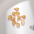 Macro view of 6mm birthstone charms with copper edges for DIY jewelry making - 6mm / Rose Gold - Yellow (November)