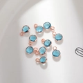 Macro shot of 6mm blue glass birthstone pendants with rose gold plated copper edges for DIY jewelry - 6mm / Rose Gold - Blue (March)