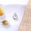 Detailed view of silver bezel set 6mm clear crystal charm with top hanging loop - 6mm / Silver - Clear (April)
