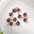 Close-up of 6mm faceted purple glass birthstone pendants with gold copper plating - 6mm / Gold - Purple (February)