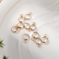 Detailed view of 6mm round crystal glass pendants with gold bezels on a ceramic plate - 6mm / Gold - Clear (April)